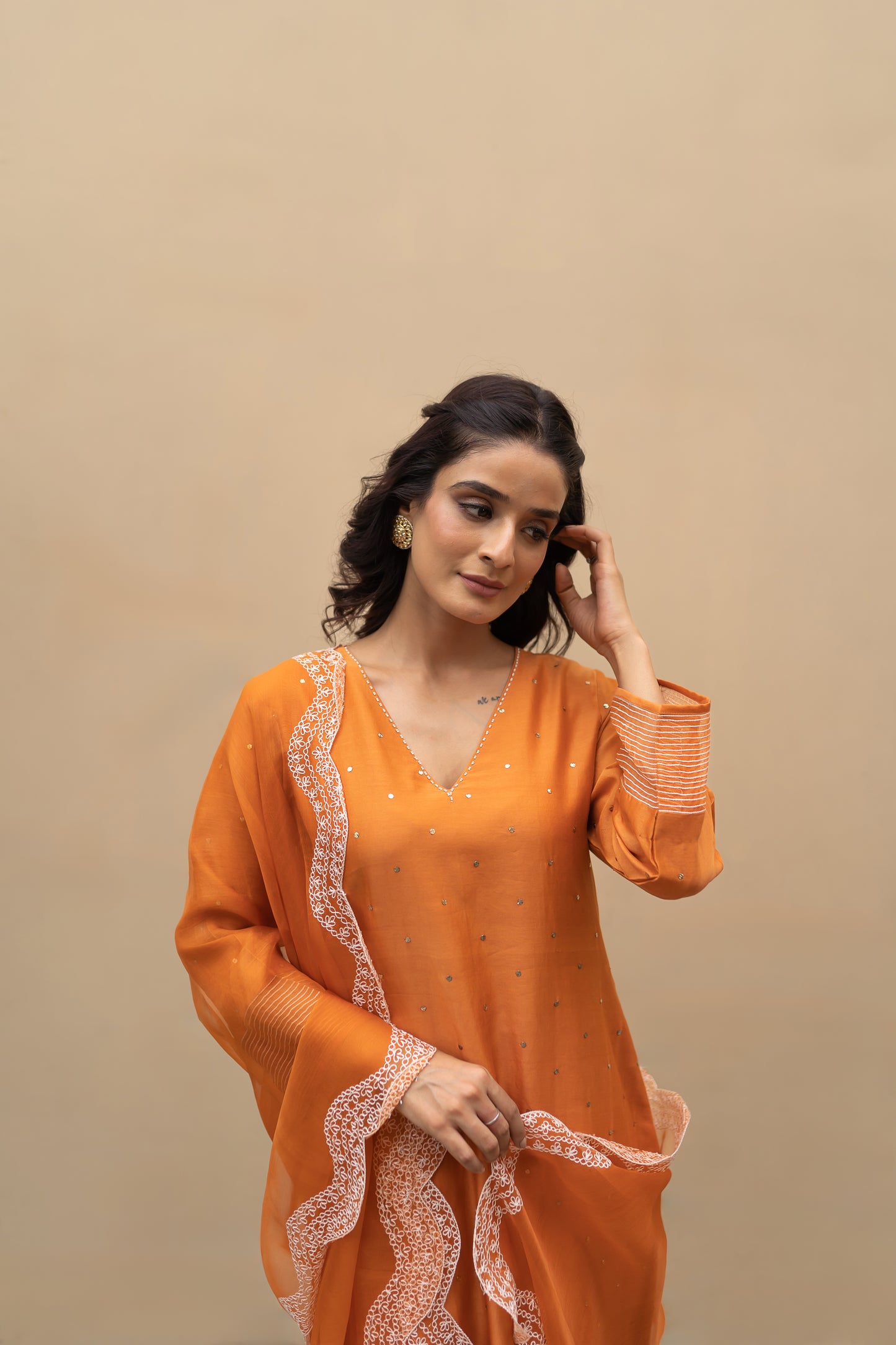 Burnt Orange chanderi Mukaish kurta with aari work on pants and dupatta.